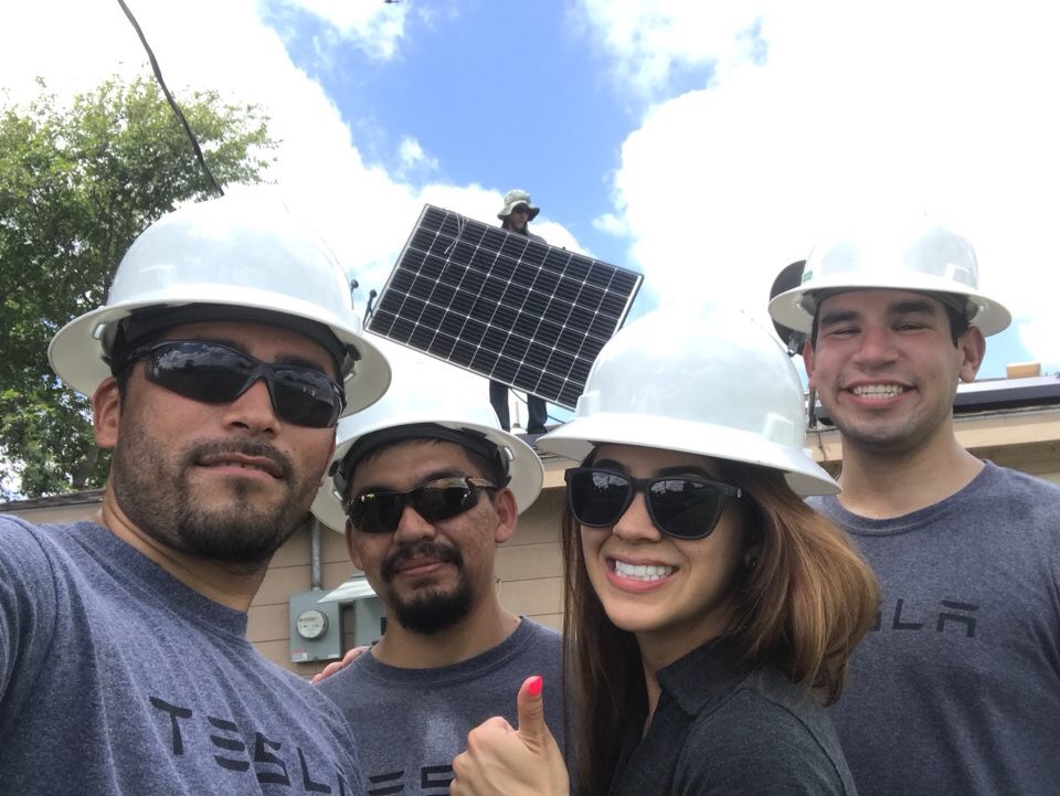 Tesla Solar installation crew on rooftop